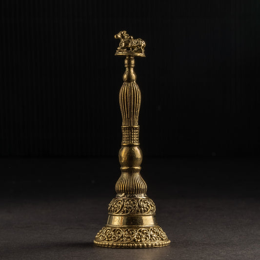 Gold-colored decorative object on a black background