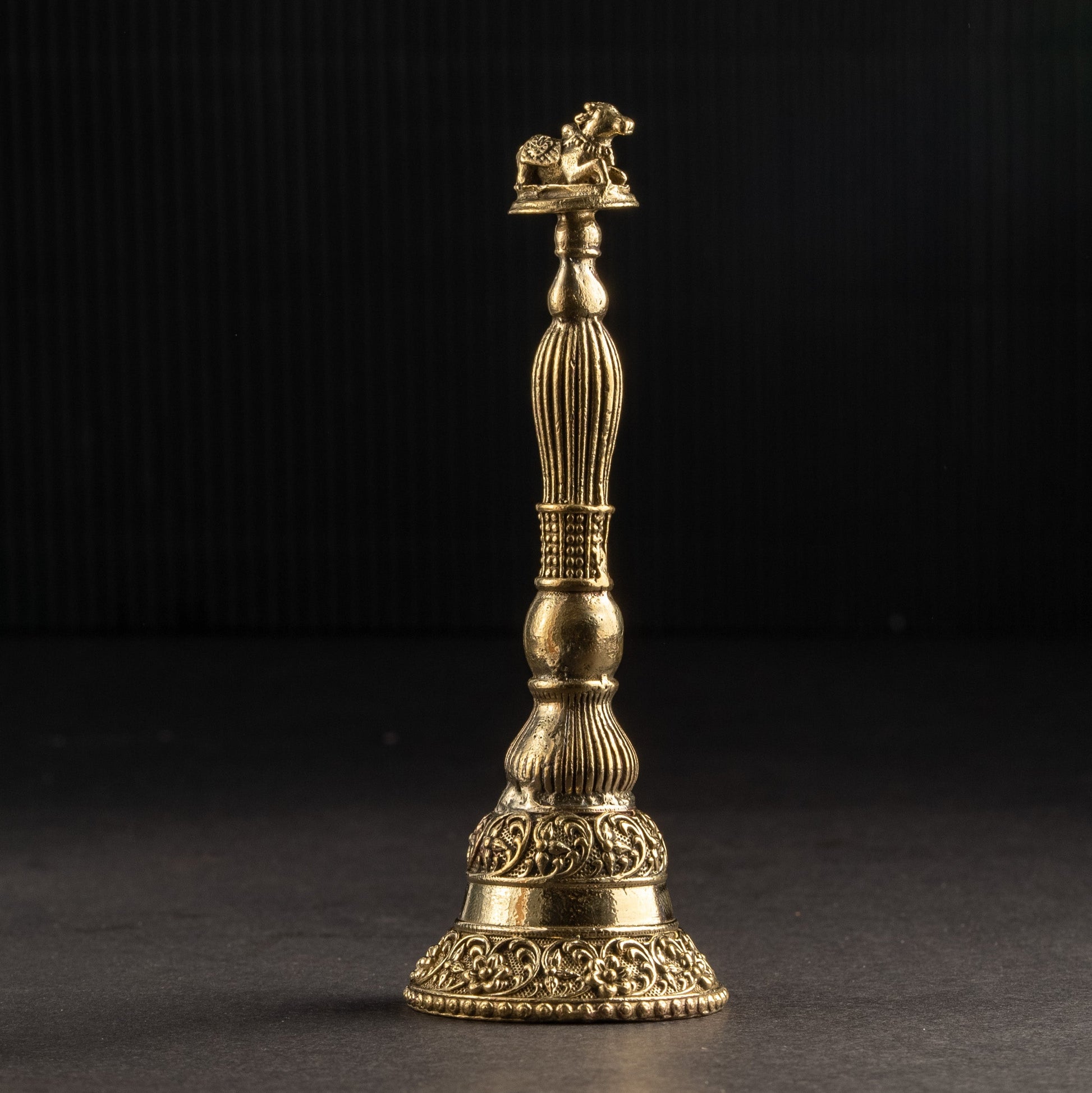 Gold-colored decorative object on a black background