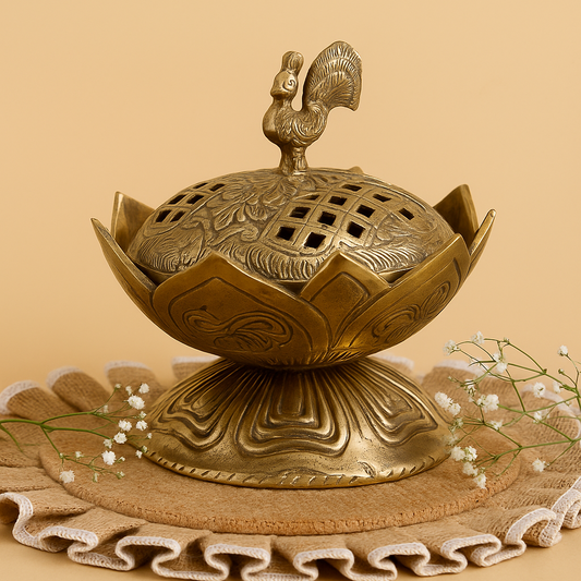 Decorative brass incense burner with intricate design on a beige background
