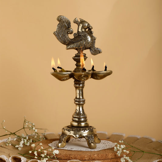 Decorative brass lamp with candles on a textured surface and beige background