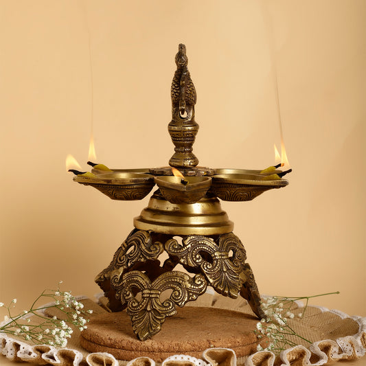 Decorative brass lamp with intricate design on a beige background