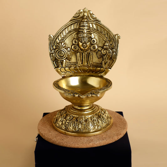 Decorative brass lamp with intricate designs on a beige background