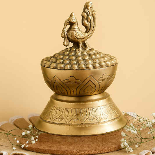 Decorative brass object with intricate designs on a beige background