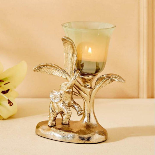 Decorative candle holder with elephant and leaf design on a beige background