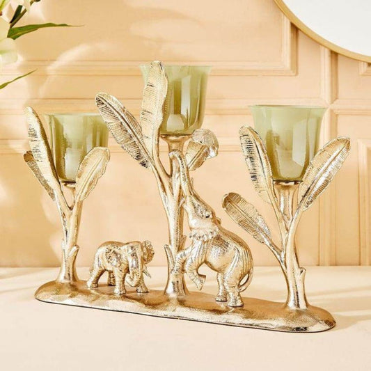 Decorative candle holder with elephant design on a beige surface
