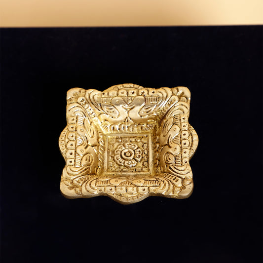 Decorative gold square object on a black background