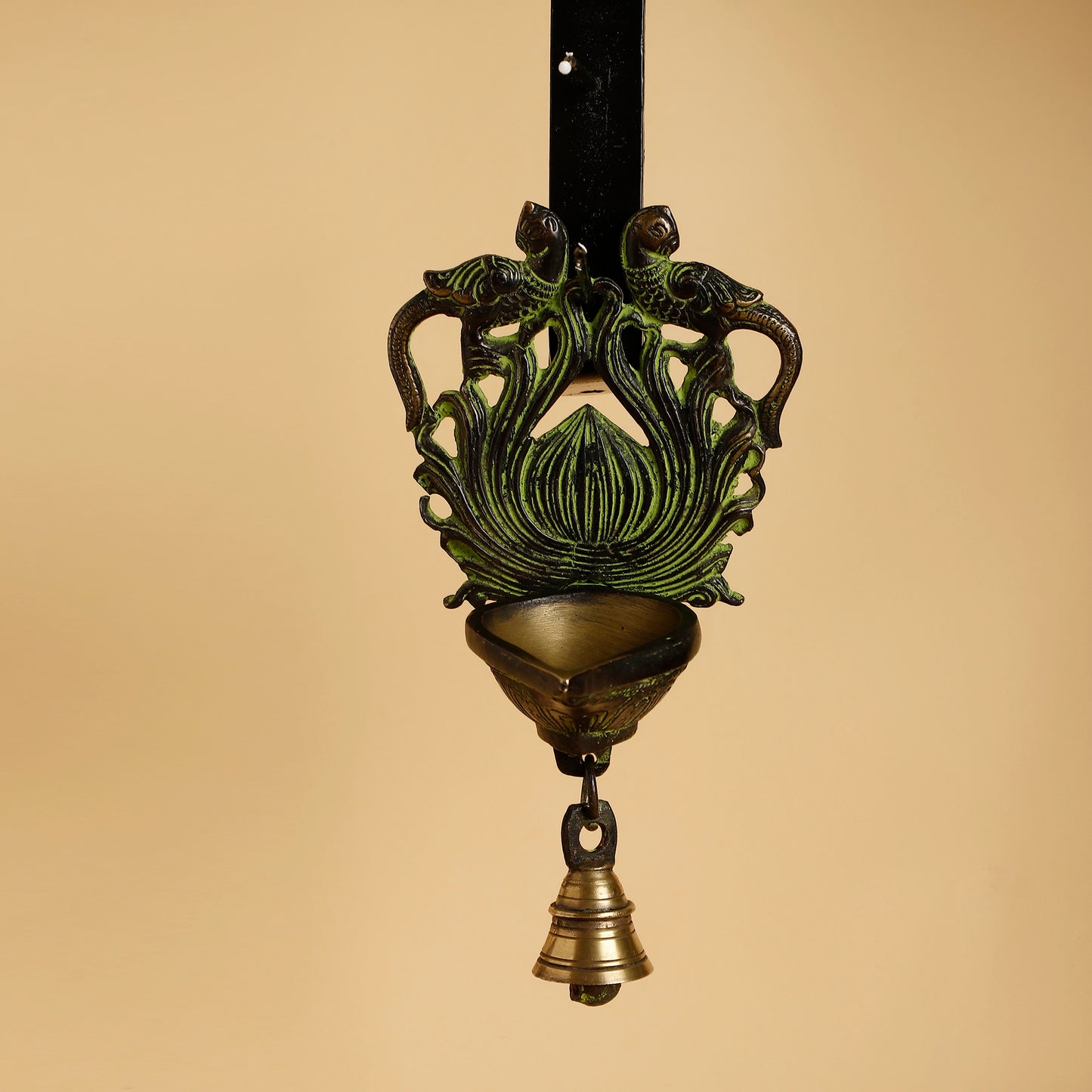 Decorative hanging lamp with intricate design on a beige background
