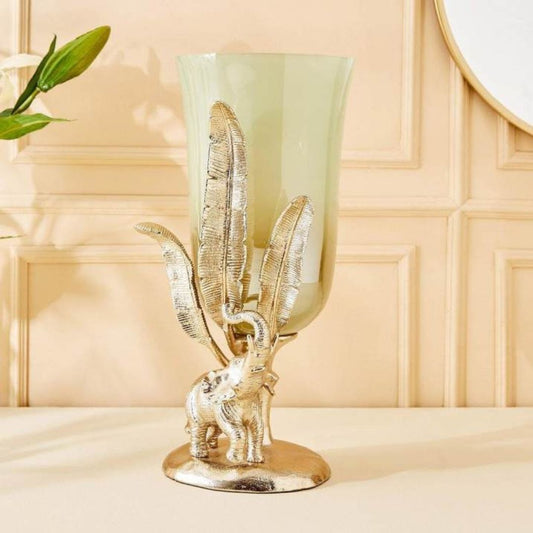 Decorative lamp with elephant and leaf design on a beige surface