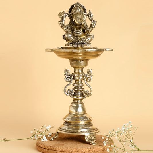 Decorative metal lamp with Ganesha figure on a beige background