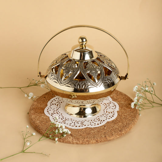 Decorative metal lantern with intricate designs on a beige background