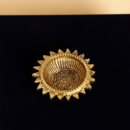 Gold decorative item on a black background