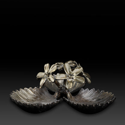 Decorative metal piece with floral design on a black background