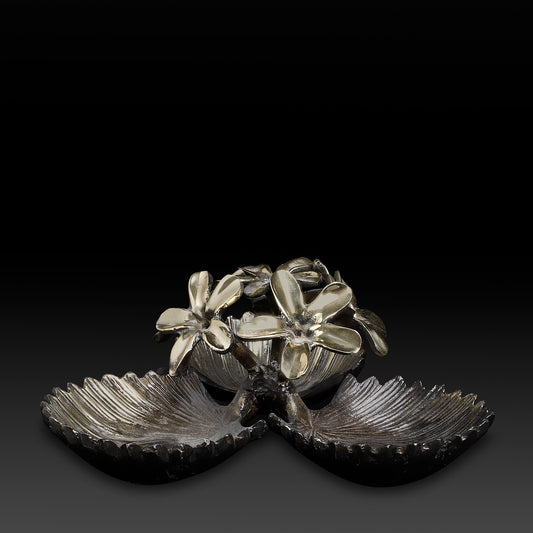 Decorative metal piece with floral design on a black background