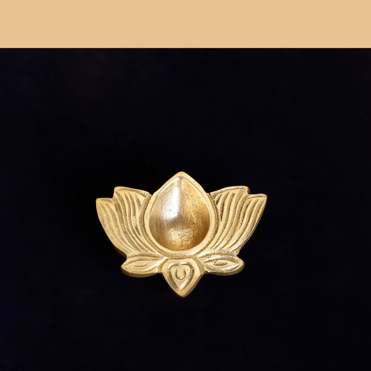 Gold lotus flower brooch on a black background