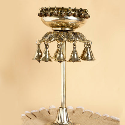 Decorative metal bell structure on a beige background