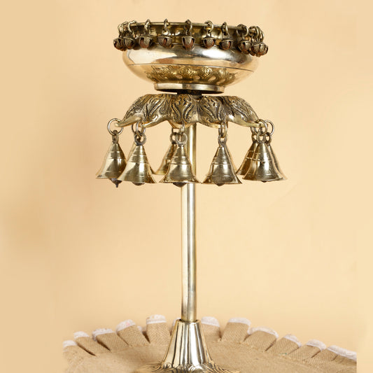 Decorative metal bell structure on a beige background