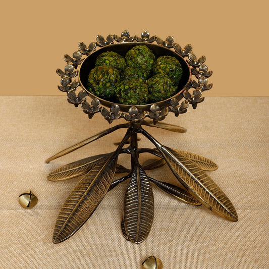 Decorative metal holder with green substance on a beige background
