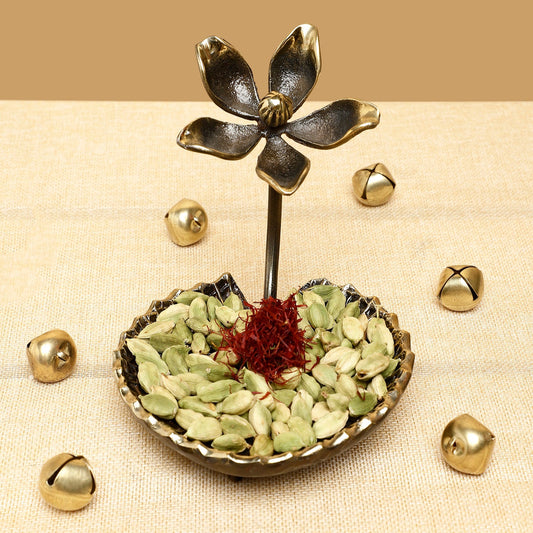 Decorative item with green seeds and a red flower on a beige background
