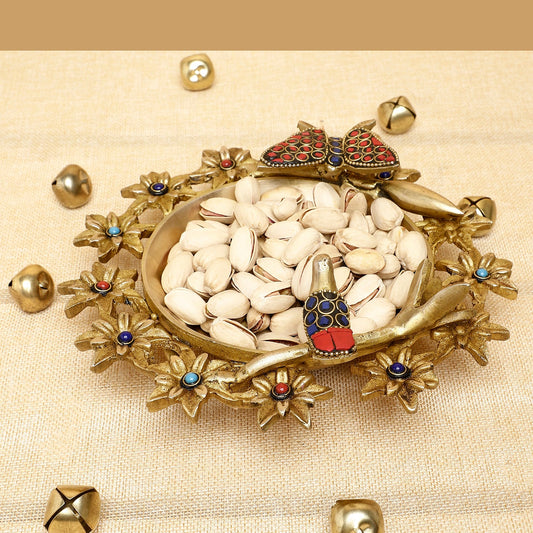 Decorative dish with stones and small figurines on a beige background