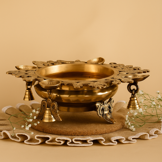Decorative brass bowl with intricate designs on a beige background