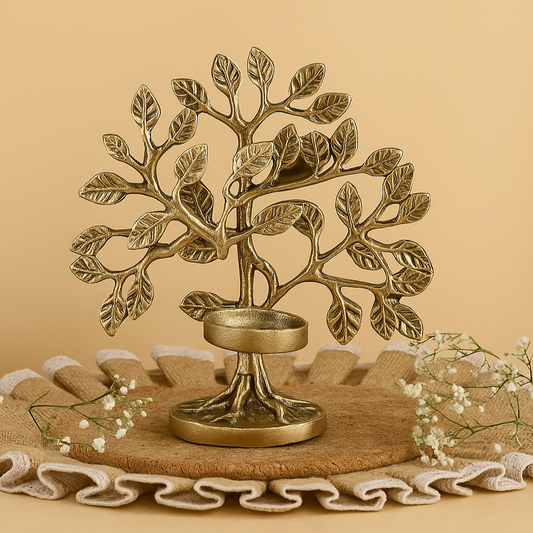 Decorative brass tree-shaped candle holder on a beige background